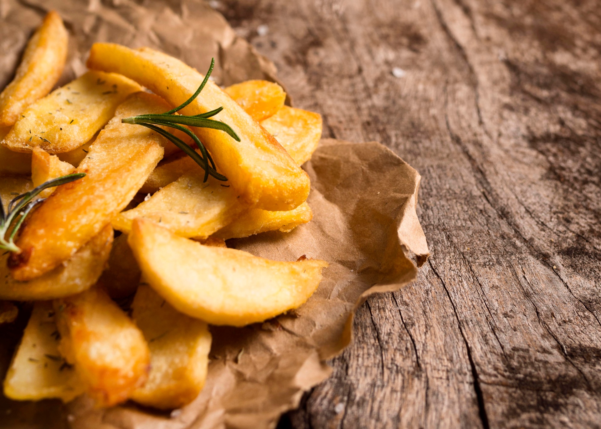 Patatas crujientes con romero sobre papel